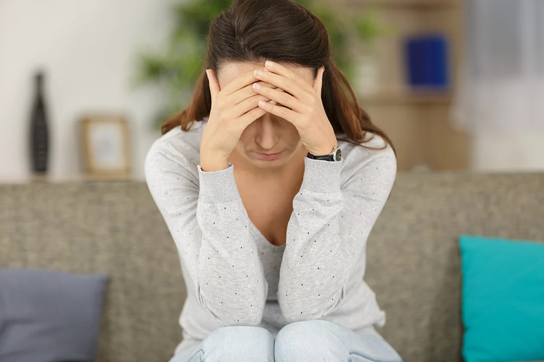 sad woman looking away at home in the living room